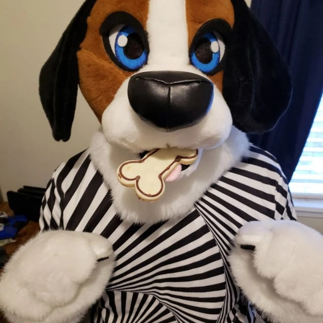 Kid wearing a ginger fursuit head and hand paws with a bone fursuit prop in their mouth