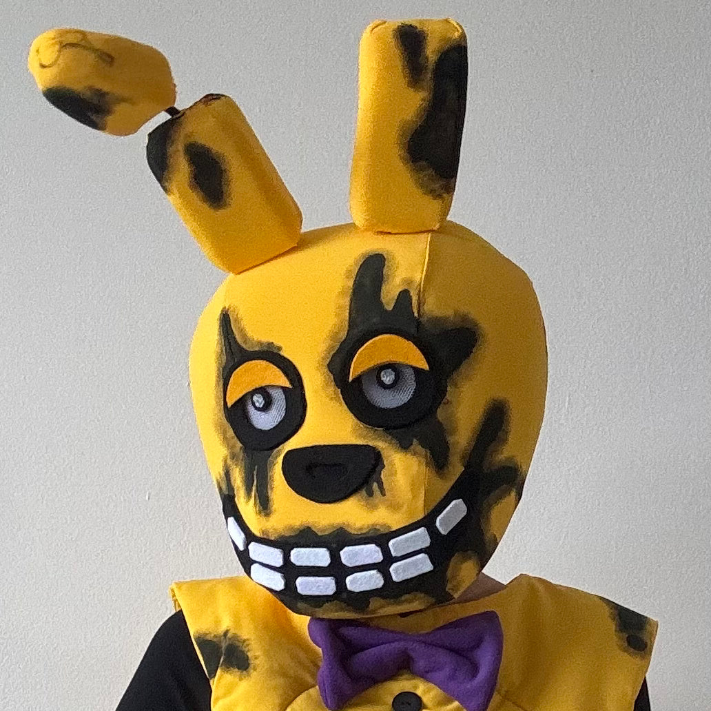 Person in yellow animatronic mask with big teeth 