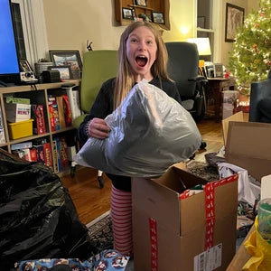 Happy 10-year-old girl receiving a fursuit for Christmas