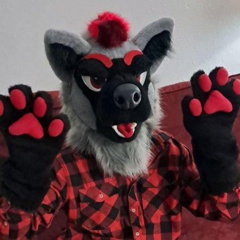 A person wearing gray red hyena fursuit head