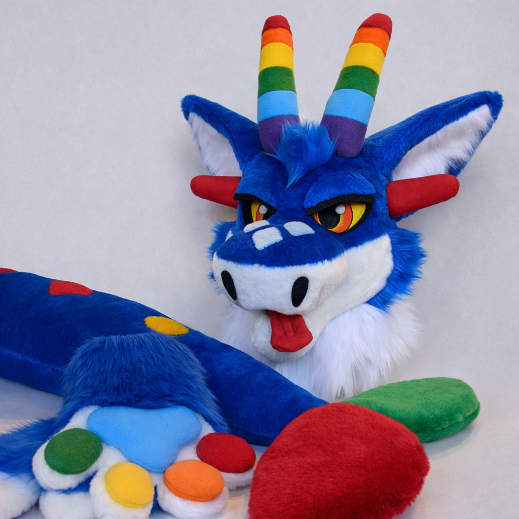 Blue rainbow dragon fursuit commission by Oneandonlycostumes in 2025