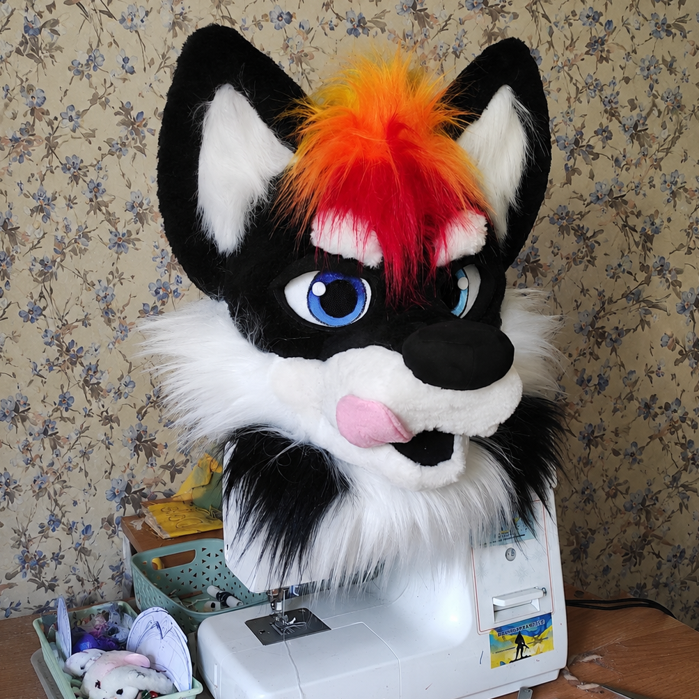 Handmade Black wolf fursuit with rainbow mohawk, rainbow paw pads, rainbow colors tail photographed on sewing machine